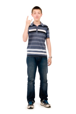 portrait of young man doing a rock and roll symbol over white backgroundの写真素材