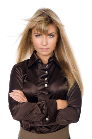 Portrait of young female standing with folded hands over white backgroundの写真素材