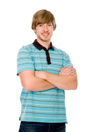 Portrait of a handsome young man staring against isolated white background. Man with arms crossed smilingの写真素材
