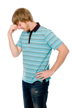 Pensive young man in a pose of a thinker. Isolated on white backgroundの写真素材