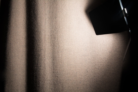 Spotlight shines rough cloth curtain scene.の写真素材
