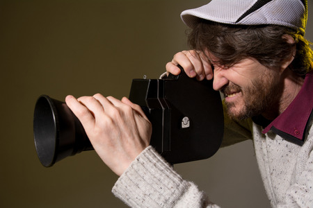 Man with retro camera shoots the film stress.の写真素材