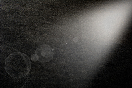 Black canvas  illuminated from the right corner spotlight の写真素材