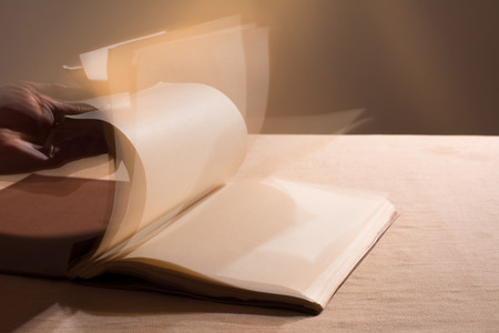 Hand leafing through the blank pages of the book.の写真素材