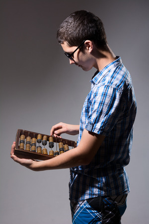 Enterprising young man with an abacus. Aspiring entrepreneur small businessの写真素材