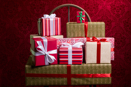 Gifts on a red background for a holiday, Christmas, anniversary.の写真素材