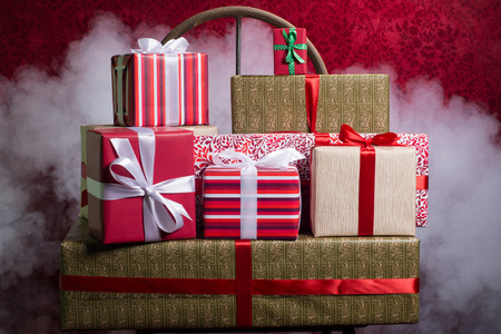 Gifts for Holidays, Christmas, anniversary on a beautiful red background with smoke.の写真素材