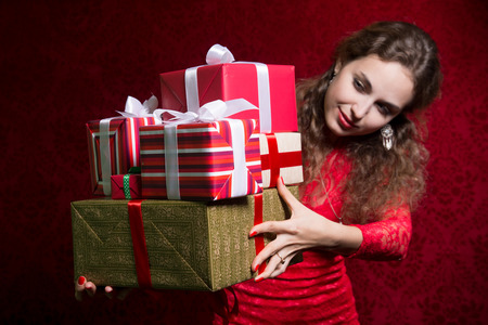 Beautiful girl holding gifts. A gift for the new year, Christmas, birthday, Valentine's Day.の写真素材