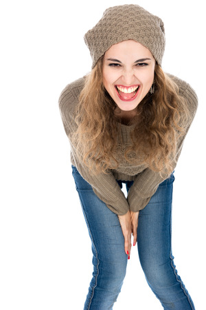 The girl in a sweater screams looking at the camera. Isolated on a white backgroundの写真素材
