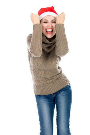 Excited young woman in a sweater clenching his fists.の写真素材