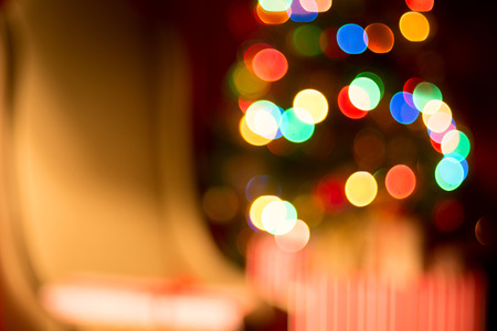Abstract christmas background, light blur creating bokeh, red white and orange.の写真素材
