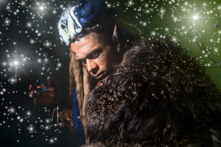 Close-up portrait of a male werewolf in the skin on a dark background with stars. Halloween....