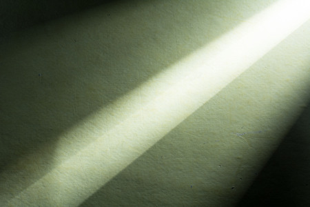 Green background illuminated from right corner spotlight and vintage grunge background textureの写真素材