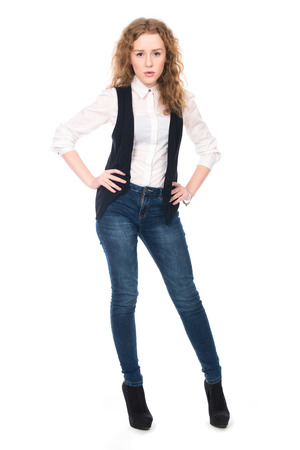 Portrait of young business girl with curly hair in jeans. Isolated on white in full lengthの写真素材