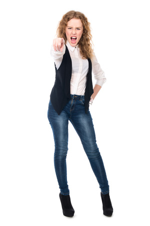 Girl screams and points his finger at the camera. Isolated on a white の写真素材