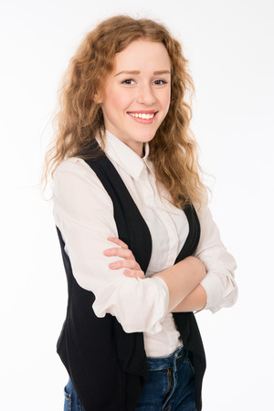 Attractive elegant cheerful young girl with curly hair. Isolated on a white の写真素材