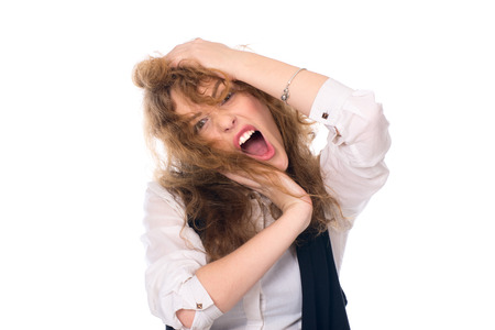 Close-up portrait of a young girl screaming. Stress business woman. Isolated on a white の写真素材