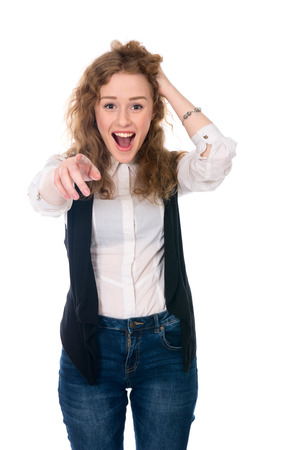 Successful business woman surprised and shows a finger at the camera. Isolated on a white backgroundの写真素材
