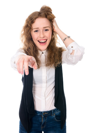 Successful business woman laughs and points at the camera. Isolated on a white backgroundの写真素材