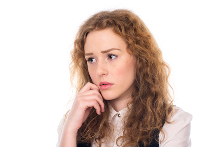 Thoughtful sad girl looking to the side. Problems in the business. Isolated on a white backgroundの写真素材
