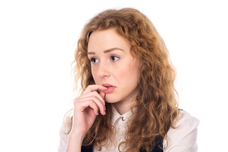 Thoughtful sad girl looking to the side. Problems in the business. Isolated on a white backgroundの写真素材
