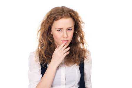 Portrait of doubtful looking beautiful young girl. Isolated on a white backgroundの写真素材