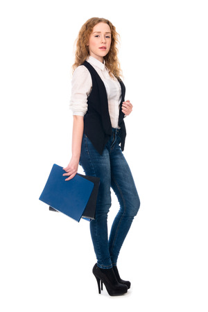 Portrait successful young business woman. Secretary in full growth with folders. Isolated on white background.の写真素材