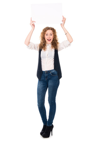 Happy successful business woman in a full-length with a blank leaf. Isolated on a white backgroundの写真素材