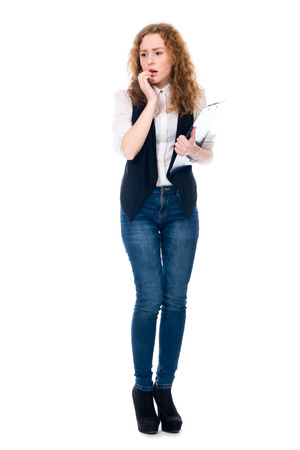 Astonished business woman with a writing tablet in full growth. Isolated on a white backgroundの写真素材