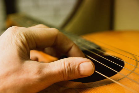 Acoustic guitar guitarist playing. Musical instrument with performer hands. Artist art song