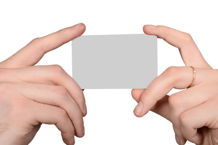 Male and female hand holding a blank card. Advertising blank sheetの写真素材