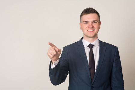 Businessman hand pushing screen on light background.の写真素材