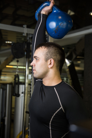 Kettlebell swing workout training man at gym.の写真素材