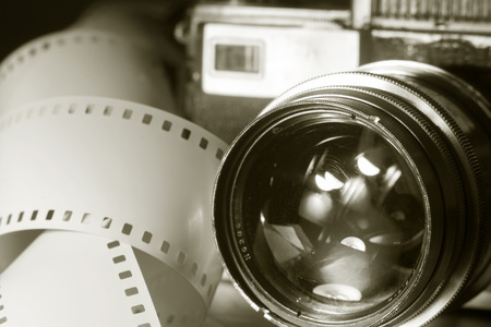 Close-up of old photo camera with metallic color. Tape 35 mm movie film. toned imageの写真素材