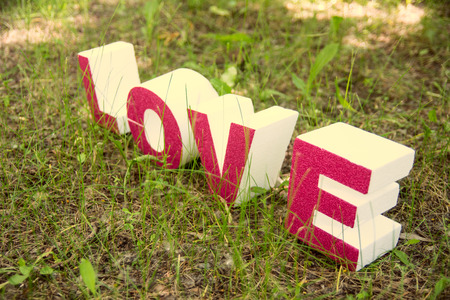 Love letters on the green grass in grunge style. Wedding backgroundの写真素材
