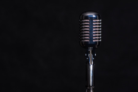 Retro metal microphone isolated on a dark background.の写真素材