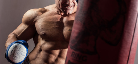 Strong muscular boxer in training. The athlete boxingの写真素材