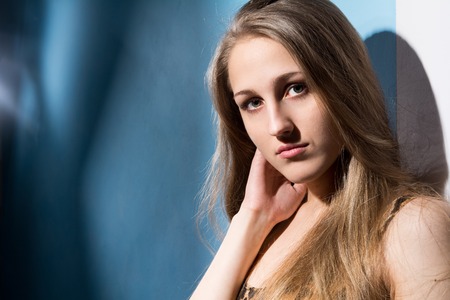 Close-up portrait of a young girl. Beautiful fashion woman looks at cameraの写真素材