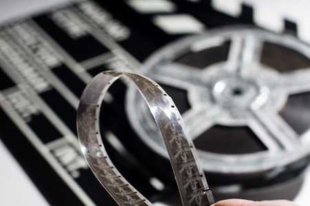 Close-up of film tape on background of film roll and clap cinemaの写真素材