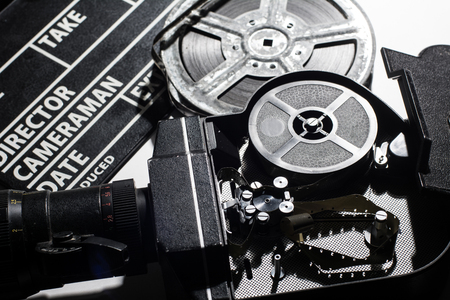 Movie Camera with the lid open. Reel with film and cinema clap.の写真素材