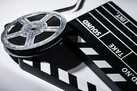 Old rusty roll of film and cinema clap.の写真素材