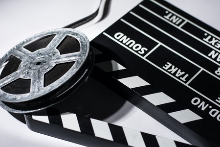 Clap movie on a light background. Metal film coil. Objects for shooting movies and demonstrationsの写真素材