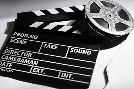 Clap cinema on the table. Metal reel of filmの写真素材