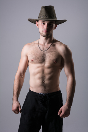Handsome man posing with a cowboy hat.の写真素材