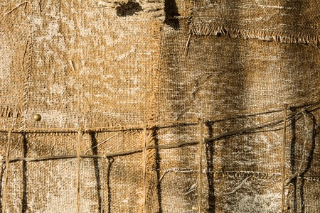 Background from an old burlap nailed to the wall.