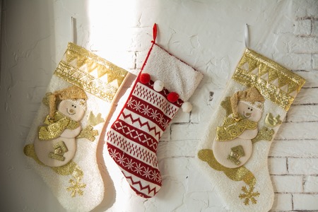 Christmas stockings on a background of a brick wall in a country houseの写真素材