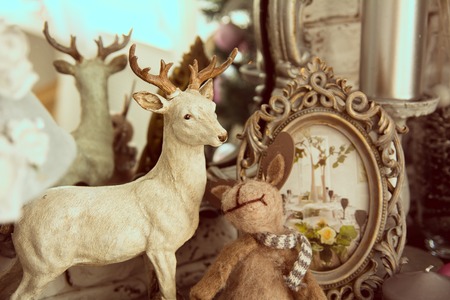 Element shelf with a mirror and standing deer and hare and frame with photos in retro styleの写真素材
