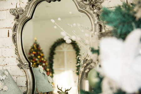 In the reflection mirror Christmas tree and decorated archの写真素材
