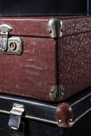 Close-up of a stack of vintage shabby suitcases. Concept traveler distant countries.