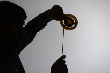 Silhouette of man looking on 8mm film strip.の写真素材